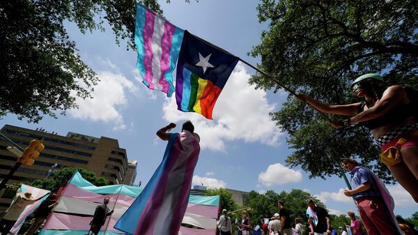 Demonstrators gather on the steps to the State Capitol to speak against transgender-related legislation bills being considered in the Texas Senate and Texas House, Thursday, May 20, 2021 in Austin, Texas. - Sputnik International