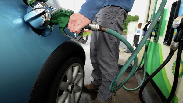 A man refuels a car with petrol at a petrol station in Manchester, north-west England. File photo - Sputnik International