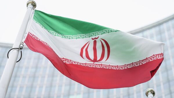 FILE - The flag of Iran waves in front of the the International Center building with the headquarters of the International Atomic Energy Agency, IAEA, in Vienna, AustriaI, May 24, 2021. On Monday, Nov. 29, 2021, negotiators are gathering in Vienna to resume efforts to revive Iran's 2015 nuclear deal with world powers, with hopes of quick progress muted after the arrival of a hard-line new government in Tehran led to a more than five-month hiatus. (AP Photo/Florian Schroetter, FILE) - Sputnik International