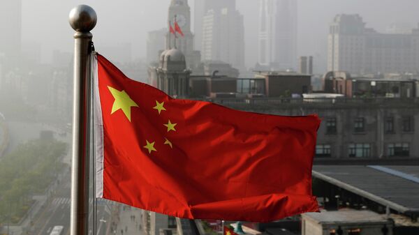 In this April 14, 2016 file photo, a Chinese national flag flutters against the office buildings in Shanghai, China.  - Sputnik International