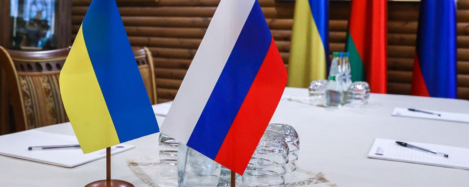 In this handout photo released by BelTA, flags are seen on a table before Russian-Ukrainian talks, in Belarus - Sputnik International, 1920, 14.03.2022