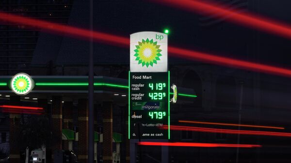 Vehicle lights pass a price board at a BP gas station in Detroit, Monday, March 7, 2022. - Sputnik International
