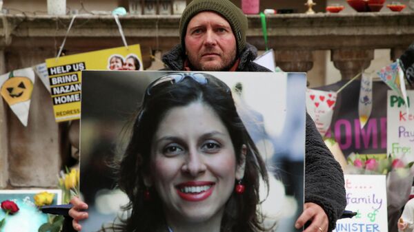  Richard Ratcliffe, husband of British-Iranian aid worker Nazanin Zaghari-Ratcliffe, holds Nazanin's picture during the 19th day of a hunger strike outside the Foreign, Commonwealth and Development Office (FCDO), in London, Britain, November 11, 2021 - Sputnik International