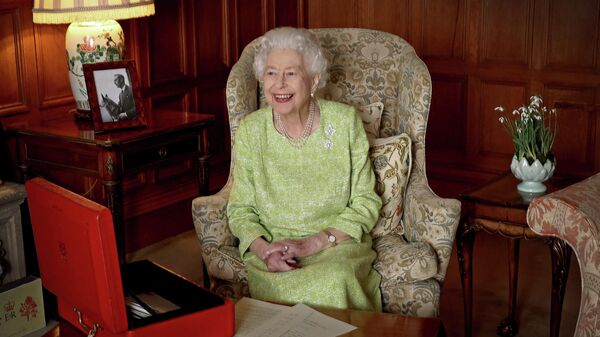 A file Buckingham Palace handout image released on February 6, 2022, shows Britain's Queen Elizabeth II smiling as she sits in Sandringham House in Norfolk, eastern England on February 2, 2022 - Sputnik International