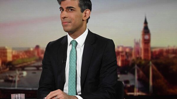 A handout picture released by the BBC, taken and received on March 20, 2022, shows Britain's Chancellor of the Exchequer Rishi Sunak appearing on the BBC's 'Sunday Morning' political television show with journalist Sophie Raworth - Sputnik International