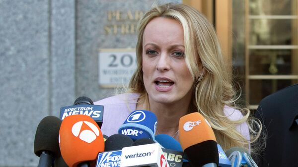 In this April 16, 2018 file photo, adult film actress Stormy Daniels speaks outside federal court in New York. Daniels, whose real name is Stephanie Clifford, said she had a one-night-stand with Donald Trump in 2006. According to President Trump's former personal attorney Michael Cohen, days before the 2016 election, Trump instructed him to pay Daniels $130,000 to keep her from talking about it. - Sputnik International