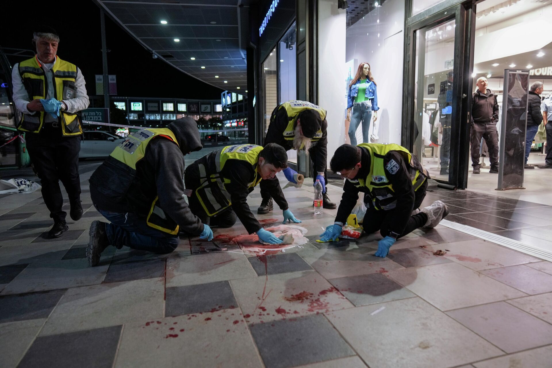 Members of Israeli ZAKA emergency and response team clean the blood stains at the scene of an attack in Beersheba, southern Israel, Tuesday, March 22, 2022 - Sputnik International, 1920, 23.03.2022