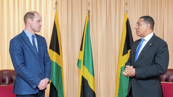 Jamaica's Prime Minister Andrew Holness speaks with Britain's Prince William during a meeting at his office, on day five of the Platinum Jubilee Royal Tour of the Caribbean, in Kingston, Jamaica, March 23, 2022 - Sputnik International