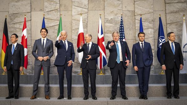From left, Japan's Prime Minister Fumio Kishida, Canadian Prime Minister Justin Trudeau, U.S. President Joe Biden, German Chancellor Olaf Scholz, British Prime Minister Boris Johnson, French President Emmanuel Macron and Italian Prime Minister Mario Draghi pose for a group photo during an extraordinary NATO summit at NATO headquarters in Brussels, Belgium, Thursday, March 24, 2022. - Sputnik International