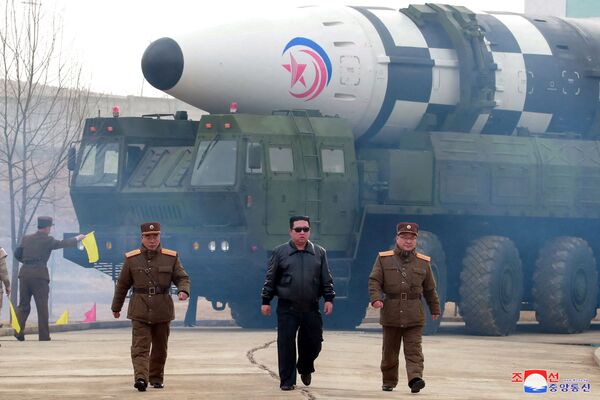 North Korean leader Kim Jong-un walks away from what state media says is a &quot;new type&quot; of Intercontinental Ballistic Missile (ICBM) in this undated photo released on 24 March 2022 by North Korea&#x27;s Korean Central News Agency (KCNA). - Sputnik International