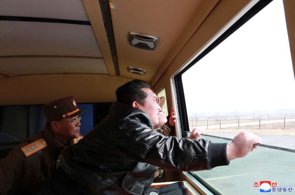 North Korean leader Kim Jong-un looks through a window during the test firing of what state media report is a &quot;new type&quot; of Intercontinental Ballistic Missile (ICBM) in this undated photo released on 24 March 2022 by North Korea&#x27;s Korean Central News Agency (KCNA). - Sputnik International