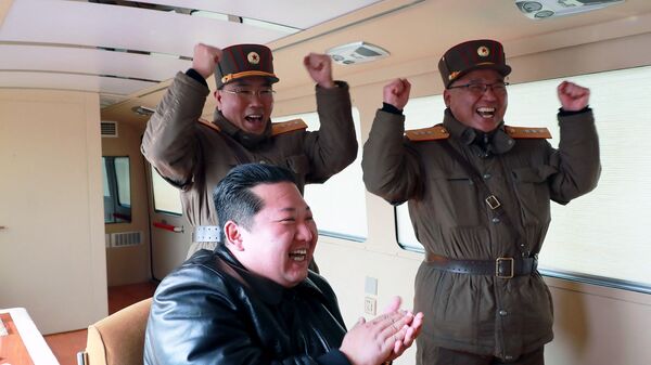This picture taken on March 24, 2022 and released from North Korea's official Korean Central News Agency (KCNA) on March 25, 2022 shows North Korean leader Kim Jong Un (C) reacting during the test launch operation of a new type inter-continental ballistic missile (ICBM), Hwasongpho-17 of North Korea's strategic forces before its test launch in an undisclosed location in North Korea.  - Sputnik International