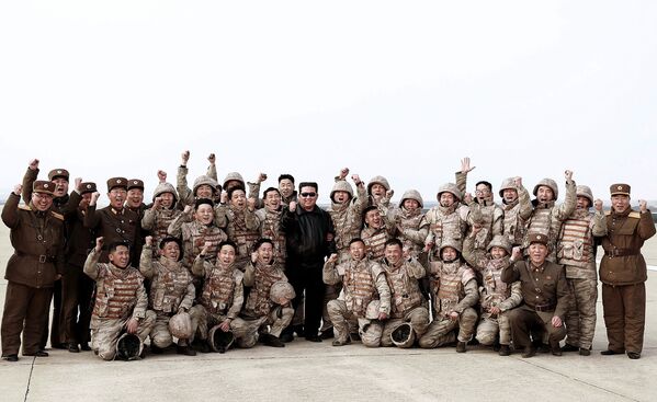This picture taken on 24 March 2022 and released by North Korea&#x27;s official Korean Central News Agency (KCNA) on 25 March 2022 shows North Korean leader Kim Jong-un (C) posing with North Korean military personnel after they took part in the test launch of a new type of Intercontinental Ballistic Missile (ICBM) Hwasong-17 of North Korea&#x27;s strategic forces in an undisclosed location in North Korea. - Sputnik International