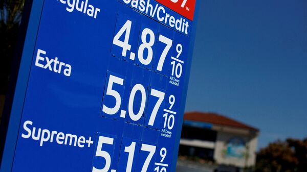 FILE PHOTO: Gas prices grow along with inflation as this sign at a gas station shows in San Diego, California, U.S. November, 9, 2021.  REUTERS/Mike Blake/File Photo - Sputnik International