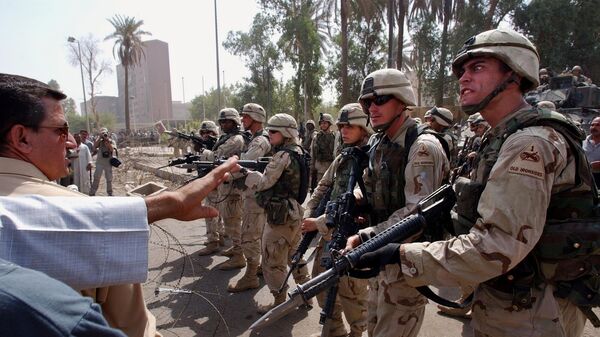 In this June 18, 2003 file photo, U.S. soldiers prevent former Iraqi soldiers from trying to enter the American headquarters during a deadly demonstration in Baghdad, Iraq.  - Sputnik International