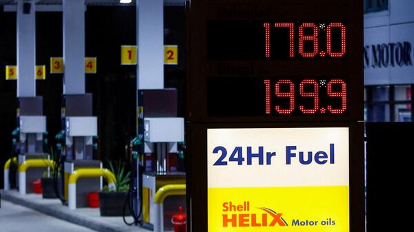 Increased fuel prices are displayed at a filling station in Long Stratton, Britain, March 10, 2022. - Sputnik International