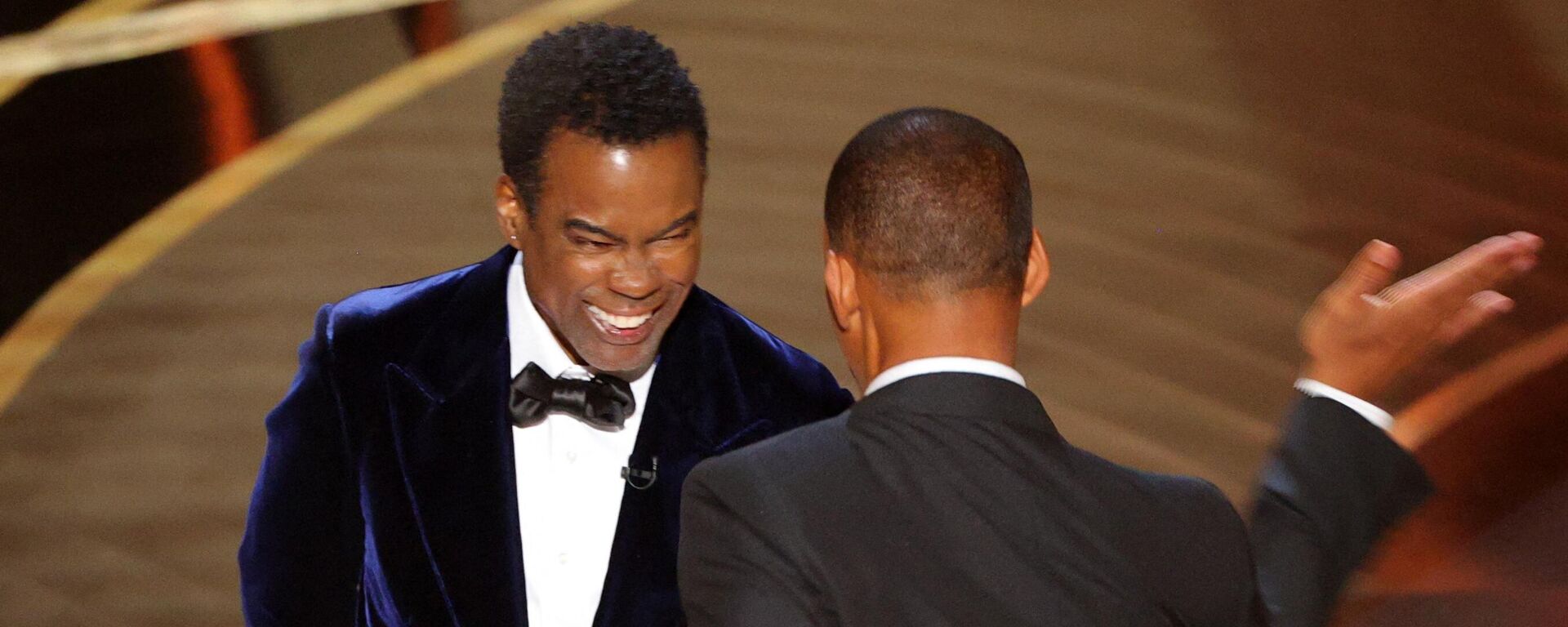 Will Smith (R) hits Chris Rock as Rock spoke on stage during the 94th Academy Awards in Hollywood, Los Angeles, California, U.S., March 27, 2022 - Sputnik International, 1920, 28.03.2022