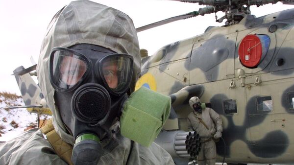 FILE PHOTO: Ukrainian soldier wears a protective suit and a gas mask during exercises of Ukrainian anti-chemical weapons forces in Kalyniv, 620 kilometers (390 miles) west of Kiev, Ukraine, - Sputnik International