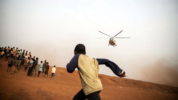 A young boy runs towards the United Nations helicopter,  Congo, Tuesday, Feb. 22, 2022 - Sputnik International