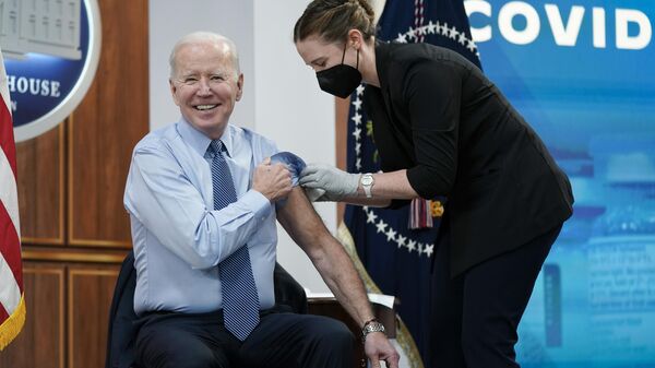 President Joe Biden reacts after receiving his second COVID-19 booster shot in the South Court Auditorium on the White House campus, Wednesday, March 30, 2022, in Washington.  - Sputnik International