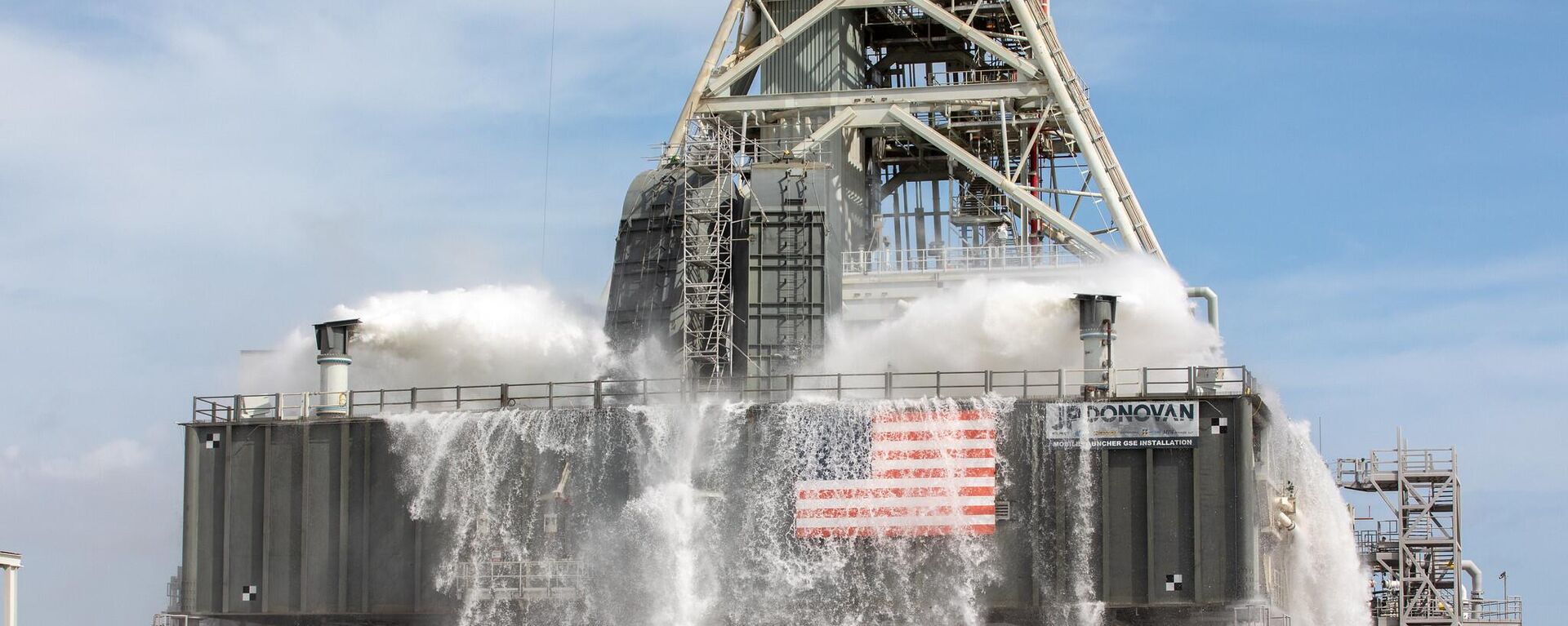About 450,000 gallons of water poured onto the Pad B flame deflector, the mobile launcher flame hole and onto the launcher’s blast deck during NASA's water flow test on September 13, 2019.  - Sputnik International, 1920, 20.07.2022