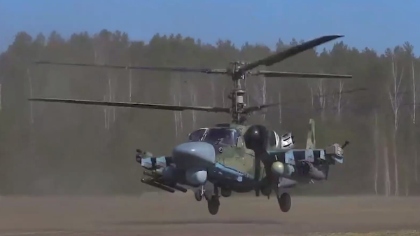 A screenshot of a video depicting a Ka-52 attack helicopter hitting Ukrainian positions. - Sputnik International
