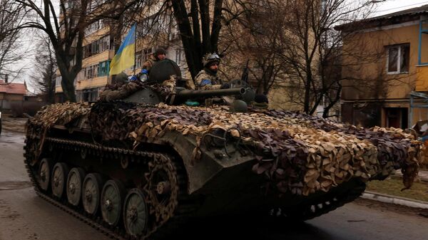 Ukrainian soldiers are pictured on their military vehicle in Kyiv region, Ukraine April 2, 2022 - Sputnik International