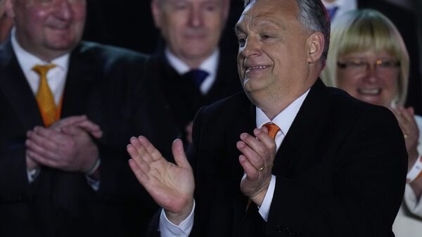 Hungary's Prime Minister Viktor Orban acknowledges cheering supporters during an election night rally in Budapest, Hungary, Sunday, April 3, 2022. Early partial results in Hungary's national election are showing a strong lead for the right-wing party of pro-Putin nationalist Orban as he seeks a fourth consecutive term.  - Sputnik International