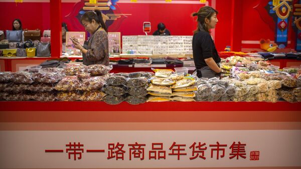 Clerks stand at a display of goods at a Belt and Road Products New Year's Marketplace at a shopping mall in Beijing, Friday, Jan. 10, 2020.  - Sputnik International