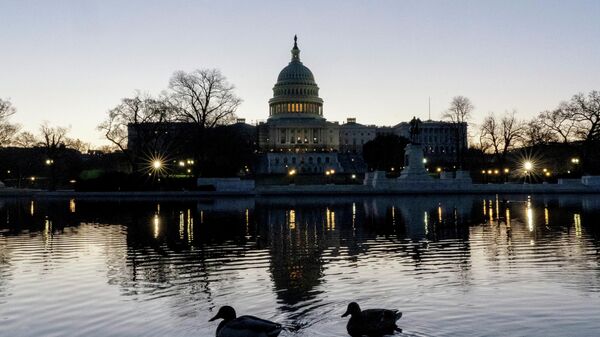 The U.S. Capitol building is seen before sunrise on Capitol Hill in Washington, Monday, March. 21, 2022. - Sputnik International