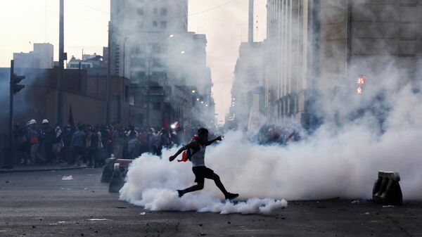A demonstrator kicks a tear gas canister during a protest against Peru's President Pedro Castillo after he had issued a curfew mandate which was lifted following widespread defiance on the streets, as protests spiraled against rising fuel and fertilizer prices triggered by the Ukraine conflict, in Lima, Peru April 5, 2022. - Sputnik International