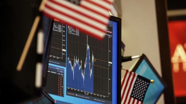 A screen displays a stock chart at a work station on the floor of the New York Stock Exchange (NYSE) in New York City, U.S., April 6, 2022. - Sputnik International