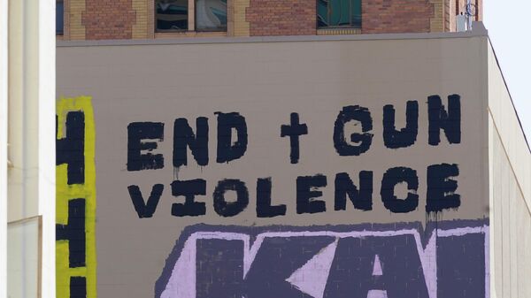 A sign calling for the end of gun violence is displayed, Wednesday, April 6, 2022, on the side of a building near the scene of a recent mass shooting in Sacramento, Calif, Multiple people were killed and injured in the shooting that occurred Sunday, April, 3, 2022. - Sputnik International