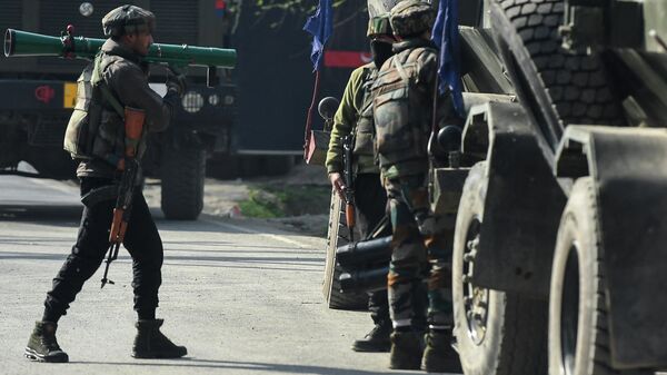 Indian army soldiers guard near the site of a gunbattle between suspected militants and government security forces in Nowgam area on the outskirts of Srinagar on March 16, 2022. ( - Sputnik International