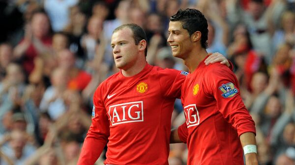 FILE PHOTO: Manchester United's English forward Wayne Rooney (L) celebrates after scoring with Manchester United's Portugese midfielder Cristiano Ronaldo during the English Premier league football match against Bolton Wanderers at Old Trafford, Manchester, northwest England, on September 27 2008.  - Sputnik International