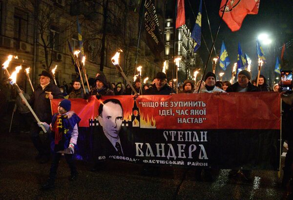 2022: Kiev. Annual torchlight procession in honour of the birth of Stepan Bandera. In Nazi Germany, torchlight processions were held on Adolf Hitler’s birthday. Text on the poster reads “Nothing will stop an idea whose time has come.” The Kremlin’s Spasskaya Tower is pictured burning in the background. - Sputnik International