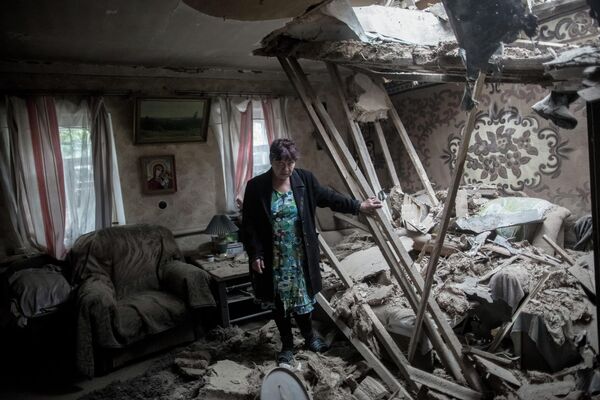A resident of Golubovka village in her home after shelling. - Sputnik International