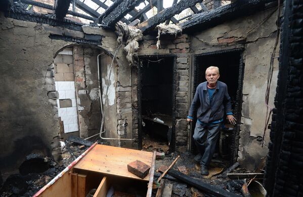 July 2014: Resident of the village of Malaya Vergunka, Lugansk People’s Republic in his home, destroyed in a Ukrainian air strike. - Sputnik International