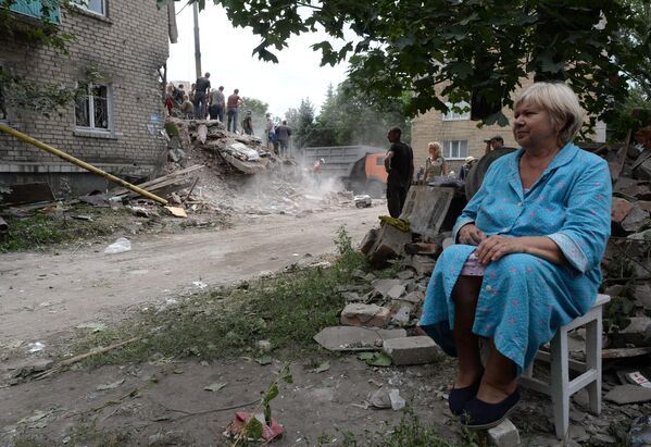 July 2014: A woman in the town of Snezhnoe, Donetsk People’s Republic sits near the ruins of her home after a Ukrainian air strike. - Sputnik International