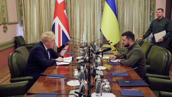 This handout picture taken and released on April 9, 2022 by Ukrainian Presidential Press Service shows Ukrainian President Volodymyr Zelensky (2R) speaking with British Prime Minister Boris Johnson (L) during their meeting in Kiev. - Sputnik International