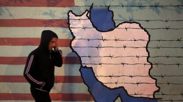 A man walks past an anti-U.S. mural, painted on the wall of the former U.S. Embassy, in Tehran, Iran, Saturday, Nov. 2, 2013. - Sputnik International
