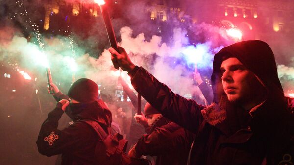 Activists of Ukrainian nationalist parties fire flares as they take part in a rally to mark the 110th anniversary of the birth of Stepan Bandera, one of the founders of the Organization of Ukrainian Nationalists (OUN), in Kiev, Ukraine. - Sputnik International