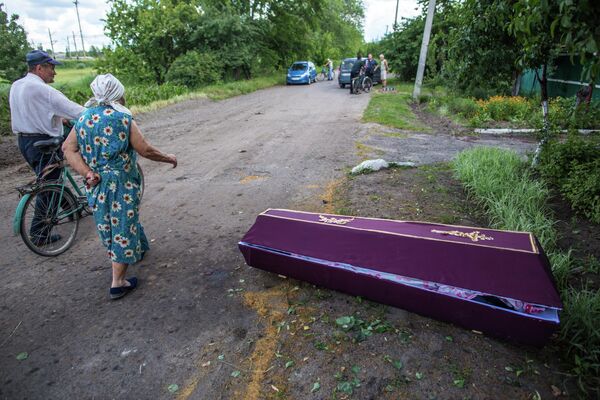 Since 2014, death has been lingering around the cities and villages of Donbass. Photo: Elderly people walking along a street in the village of Vostochny near Slavyansk, which was shelled by the Ukrainian Army. Spouses Olga and Vladimir Chernikov both died in a landmine explosion as they were walking along the street. There was no electricity in the city, meaning that the mortuary was not operating and the dead were usually buried at once. - Sputnik International