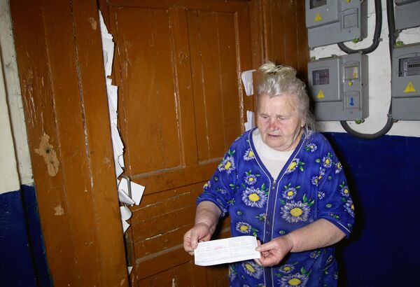 An elderly woman shows numerous utility bills to tenants who have abandoned their homes due to shelling in the village of Glubokaya in Gorlovka, which is close to the contact line in the Donetsk region. Many residents&#x27; houses overlook the front line, which is some 500 metres away, leaving few people left to live in the village. Most of them are elderly and disabled, who have become that way because they&#x27;ve been living under shelling for years. - Sputnik International
