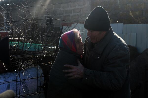 Tens of thousands of homes were destroyed during the 2014-2021 conflict in Donbass. Photo: Residents outside their destroyed house in the village of Oktyabrsky near the Donetsk airport, the site of fierce fighting between the People&#x27;s Militia and Ukrainian armed forces (UAF) in 2014-2015. - Sputnik International
