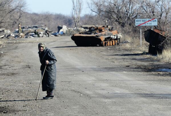 Many elderly residents have no escape from the conflict: no strength, no health, no desire to leave their homes, and no money to move away. Photo: Burnt out military equipment on the road from Uglegorsk to Debaltsevo. - Sputnik International