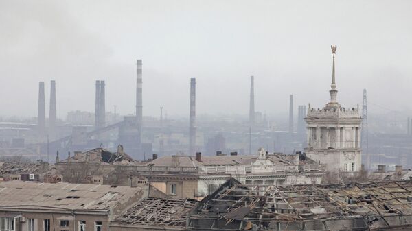 A view shows a plant of Azovstal Iron and Steel Works company behind damaged buildings in Mariupol - Sputnik International