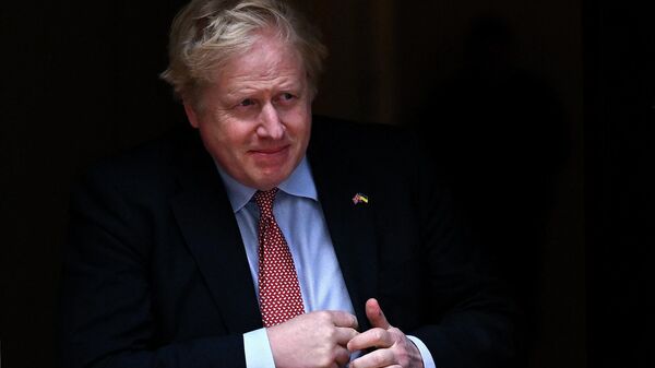 Britain's Prime Minister Boris Johnson walks out of number 10 Downing Street to greet the Polish president in London on April 7, 2022 - Sputnik International