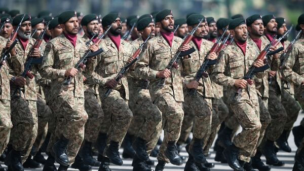 Pakistan's army soldiers march during a military parade to mark Pakistan's National Day in Islamabad on 25 March 2021. - Sputnik International