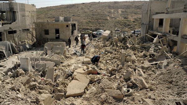 In this photo released by the Syrian official news agency SANA, people inspect damage after an Israeli airstrike near Damascus, Syria, Monday, March 7, 2022. - Sputnik International